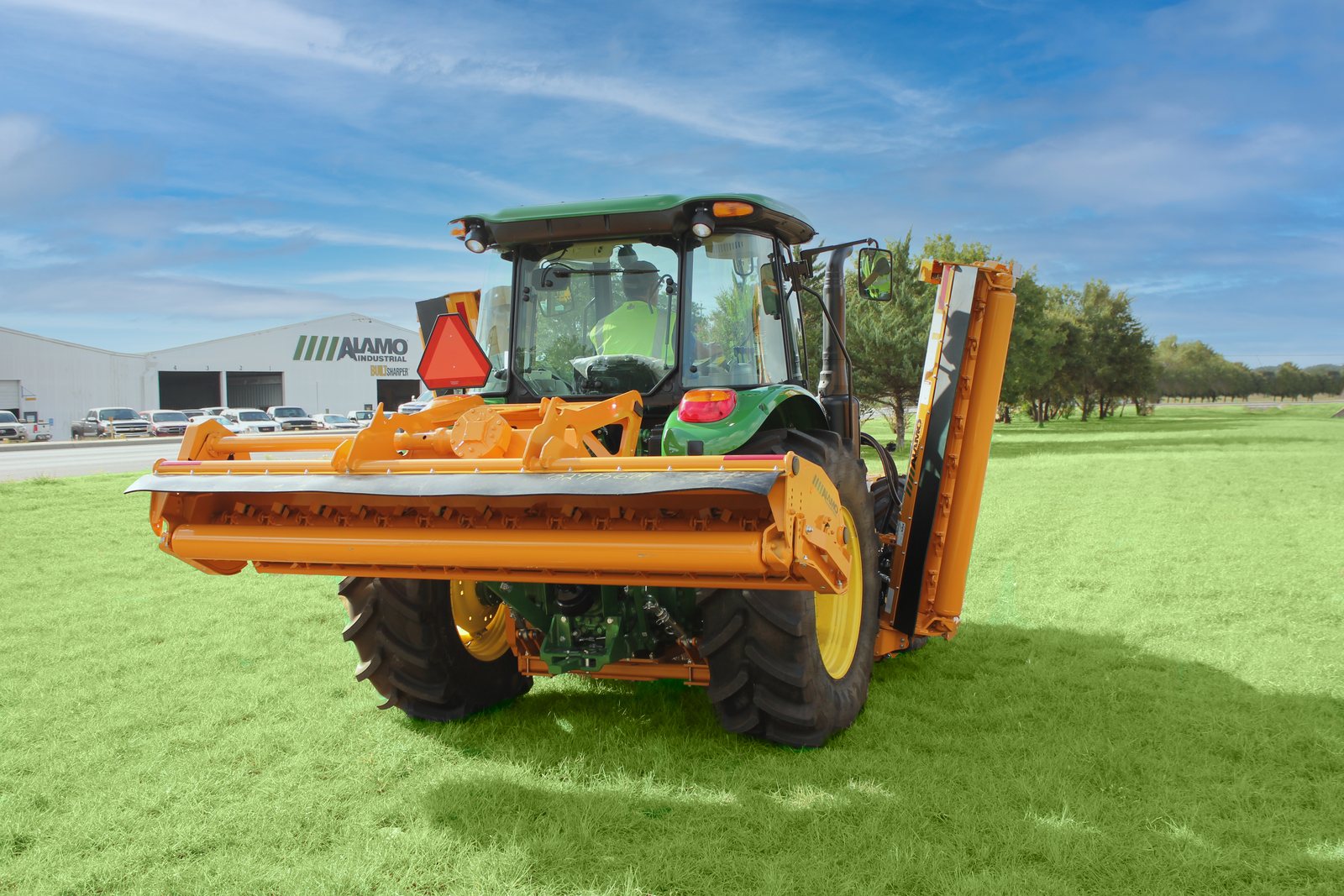 Alamo Interstater side wing folded upright for transport behind a John Deere tractor