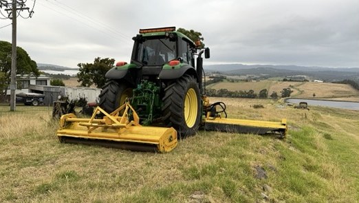 Tractor and Interstater decks set up on a sloping roadside bank