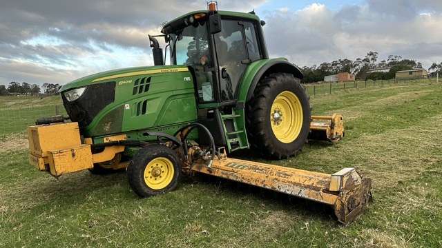 Side view of the John Deere with the Alamo side flail deck lowered